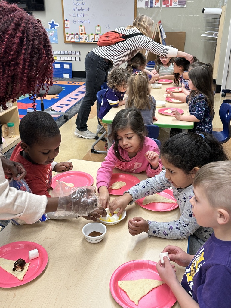 Pre-k students working with dough and marshmallows to make empty tomb rolls
