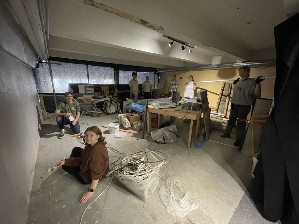 students working and painting in a church