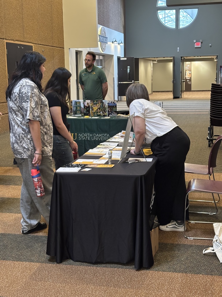 students and parents speaking to college representatives