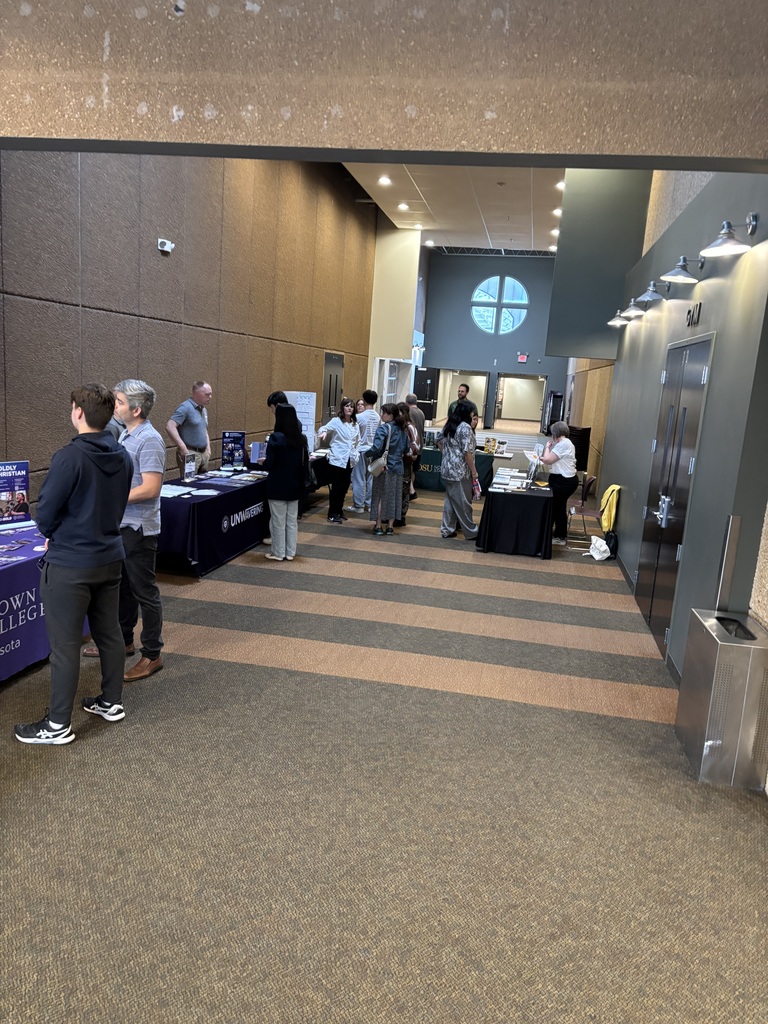 students and parents speaking to college representatives