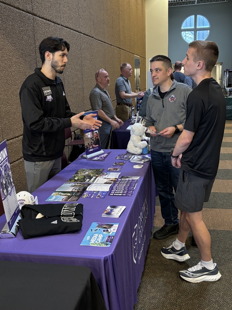students and parents speaking to college representatives