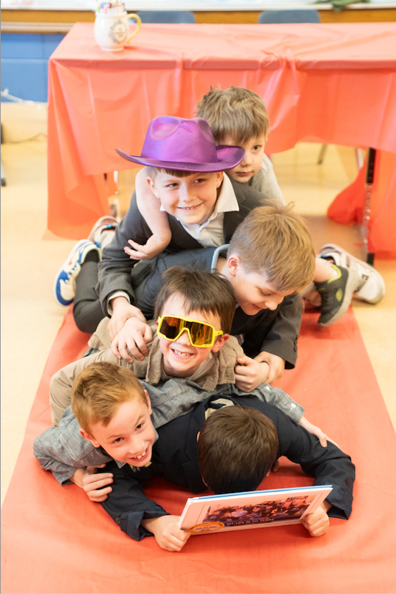 group of boys piled on the floor