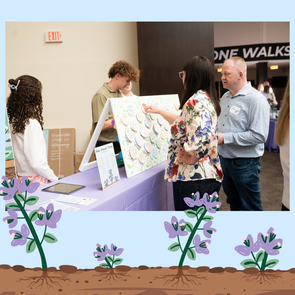 students working at a raffle table and guests buying tickets