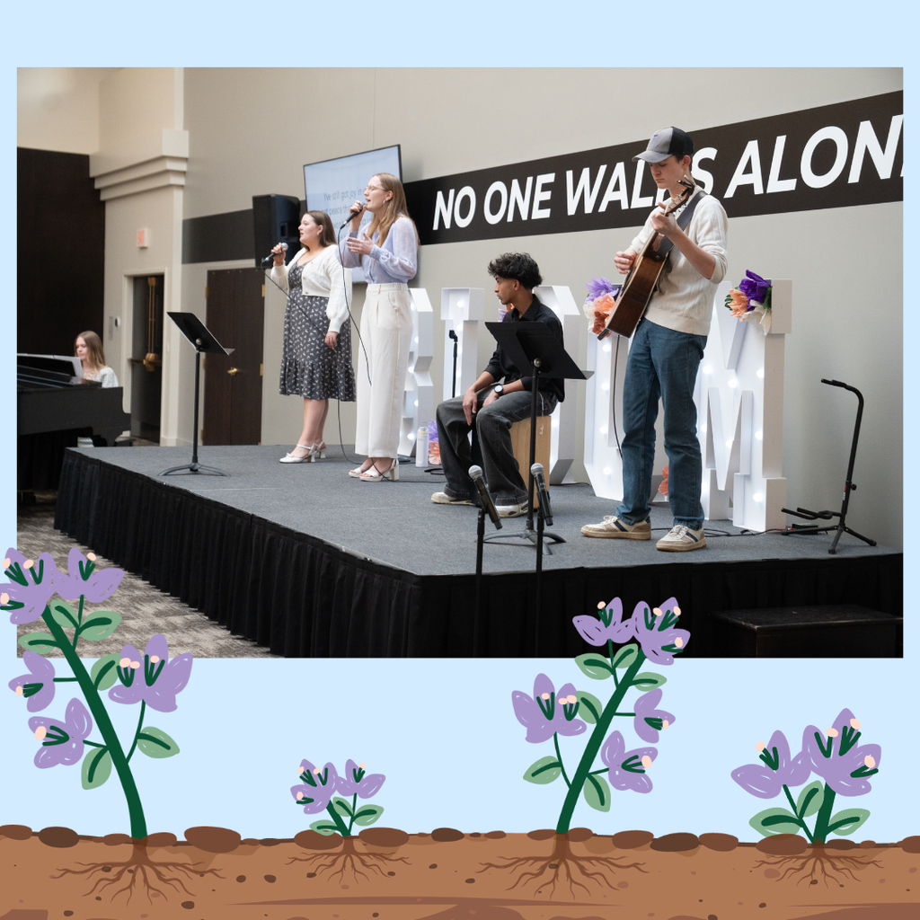 students on stage worshiping
