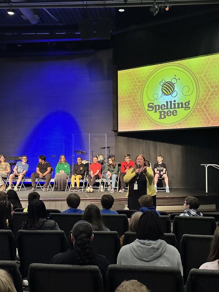 middle school dean speaking to all of the students before the spelling bee