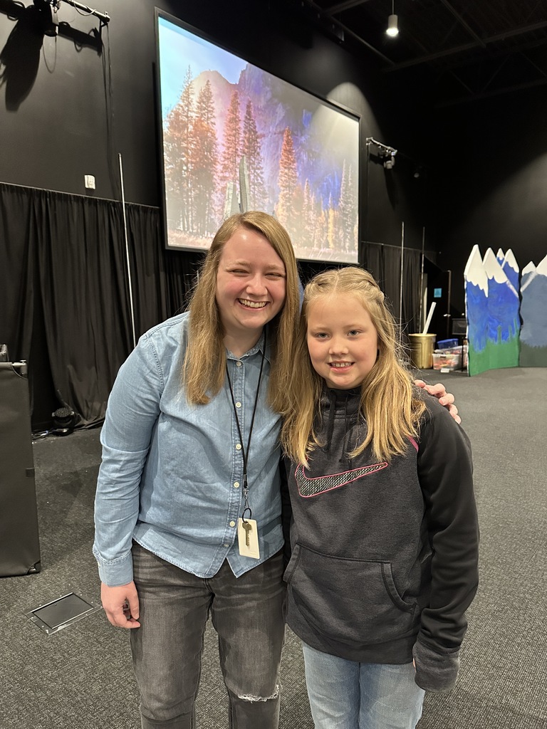 student standing next to pastor