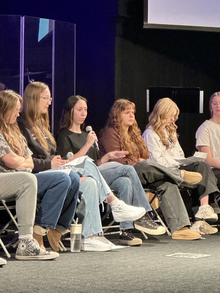 panel of high school students on a stage