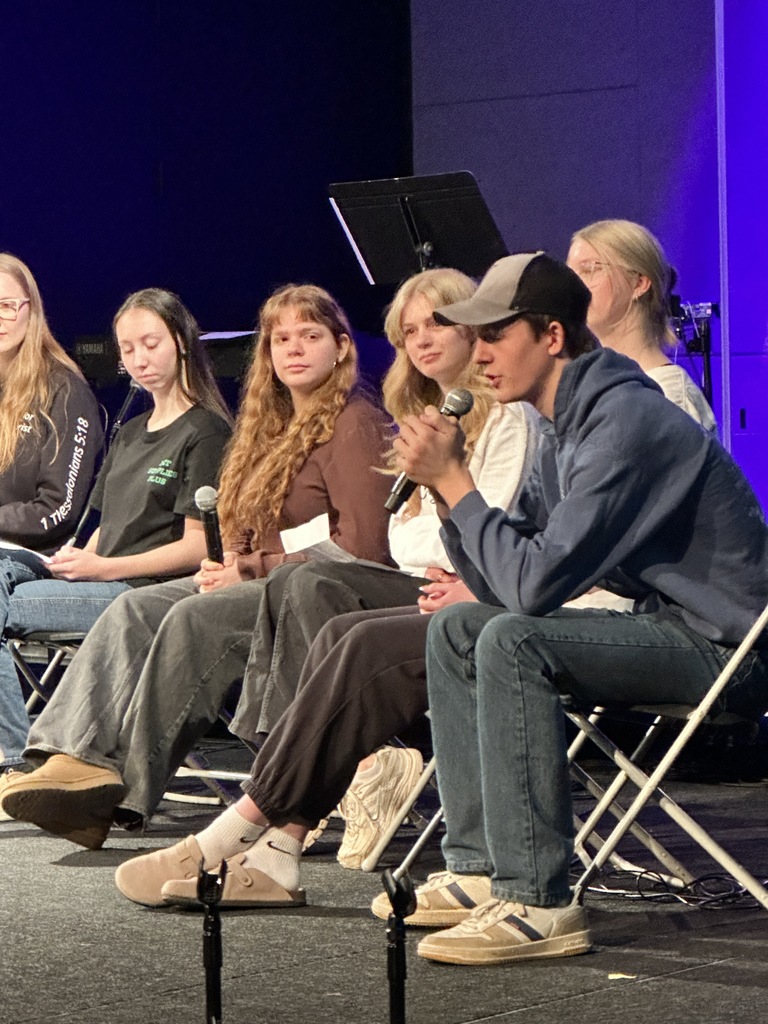 panel of high school students on a stage