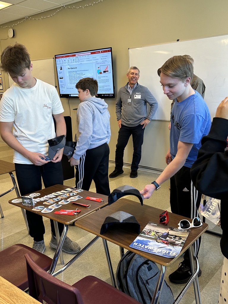 students looking at swag options laid out on a desk