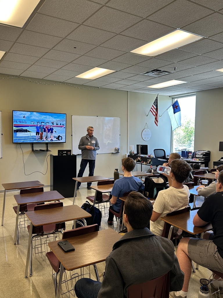 guest speaker in the front of a classroom