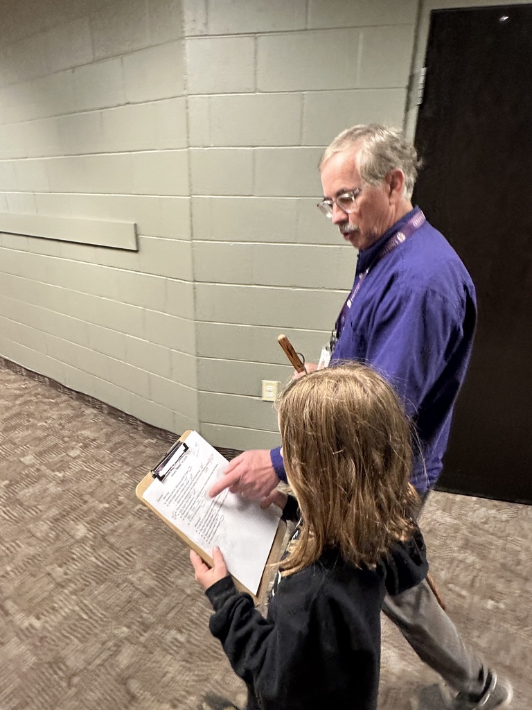 principal and student looking at a clipboard