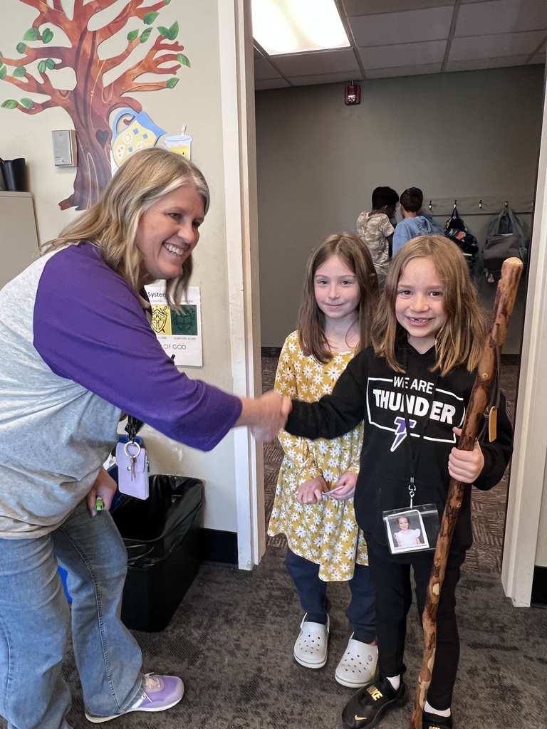 student shaking teachers hand