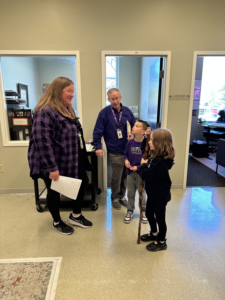 two staff members talking to two students