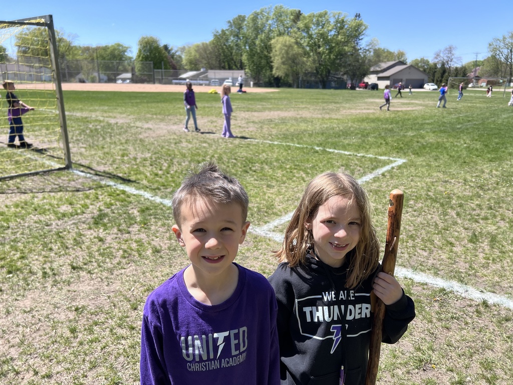students standing next to a soccer field