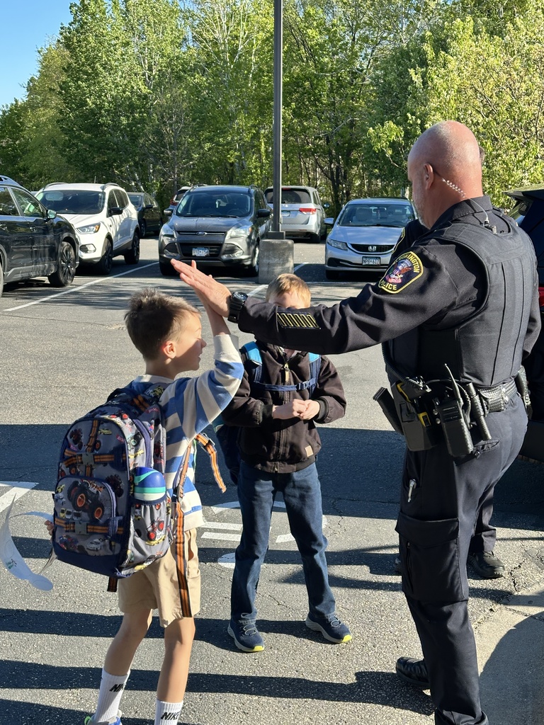 students and officers giving high fives