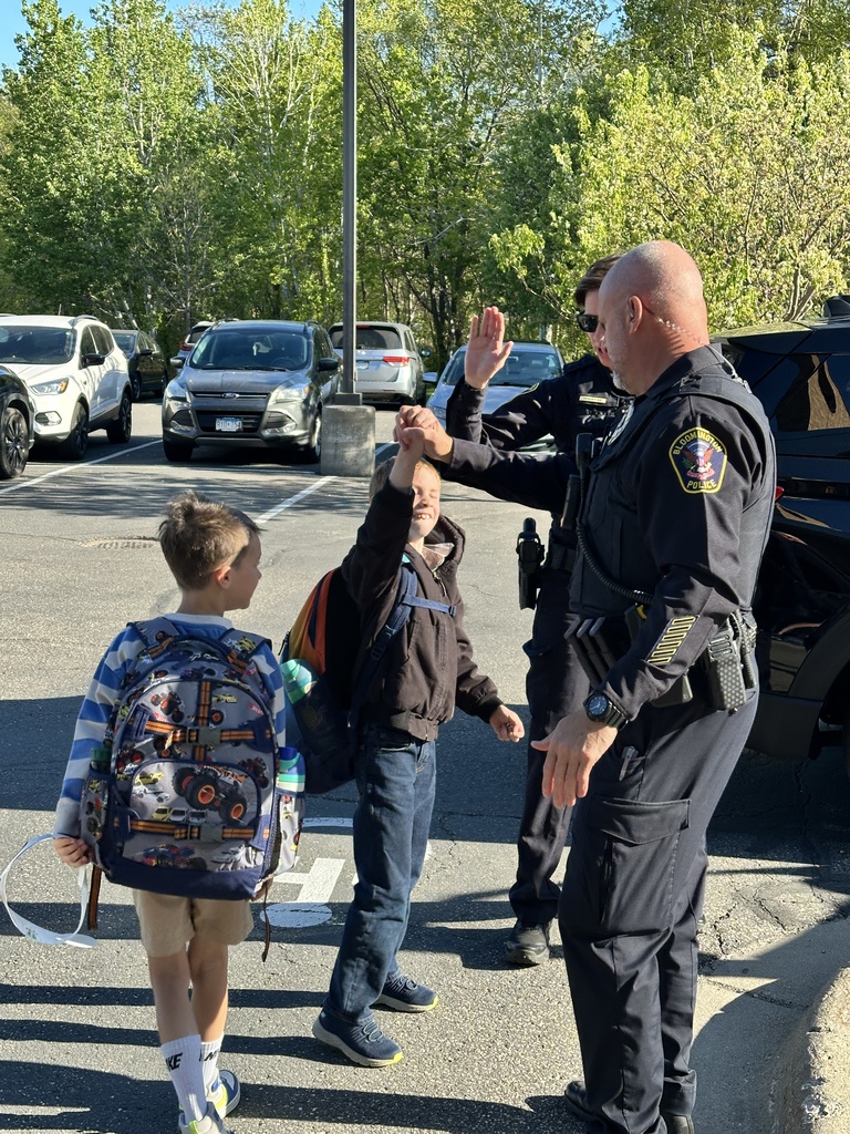 students and officers giving high fives