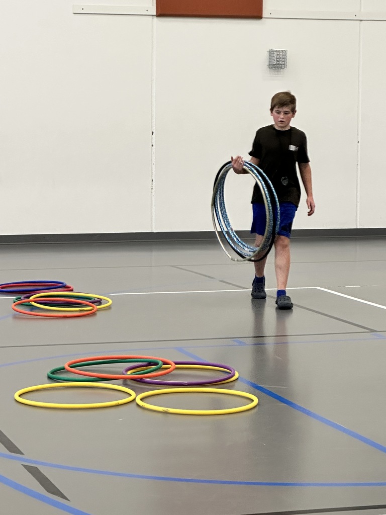 student carrying supplies for PE class
