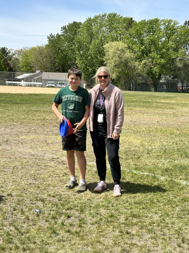 6th grade student standing with PE teacher