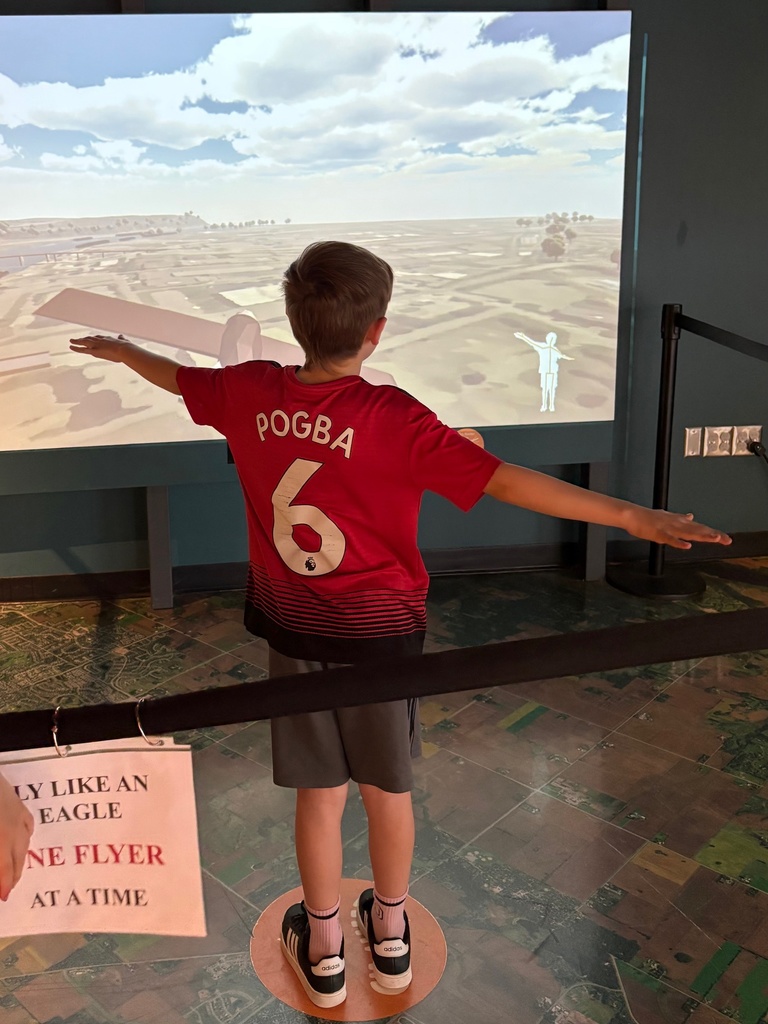 third grade students looking through exhibits at the science museum