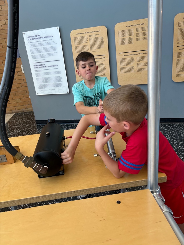 third grade students looking through exhibits at the science museum