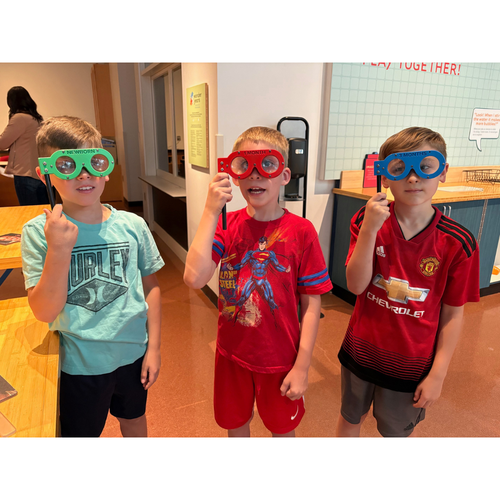 third grade students looking through exhibits at the science museum