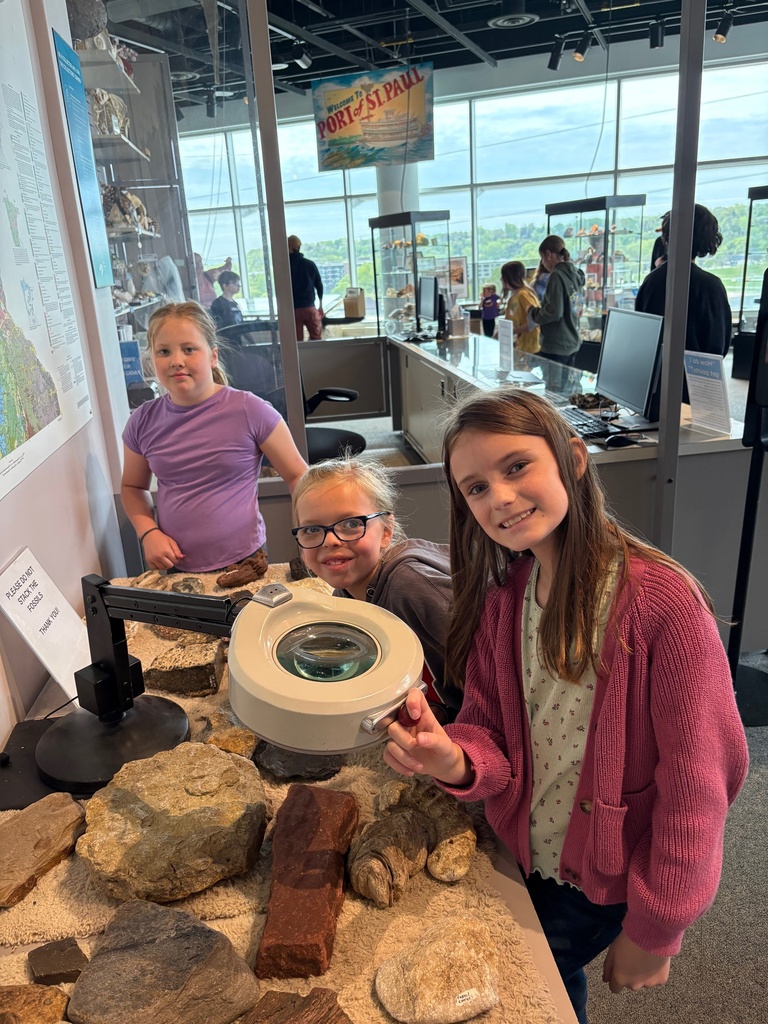third grade students looking through exhibits at the science museum