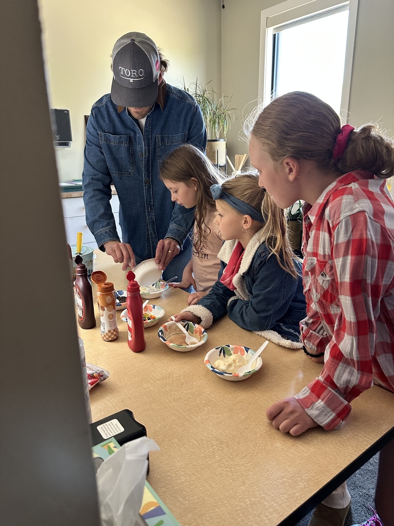 teacher scooping up ice cream for students