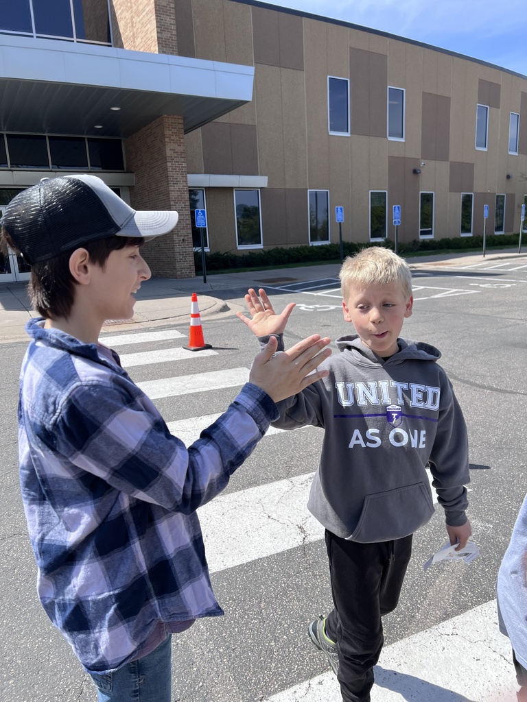 "Principal for a day" giving a high five to another student