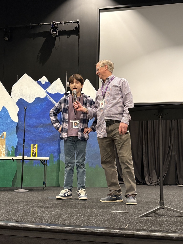 "principal for a day" speaking into a microphone