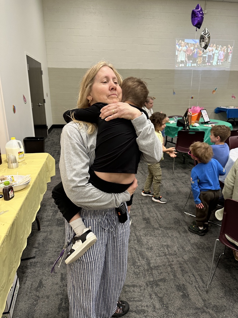 teacher hugging student