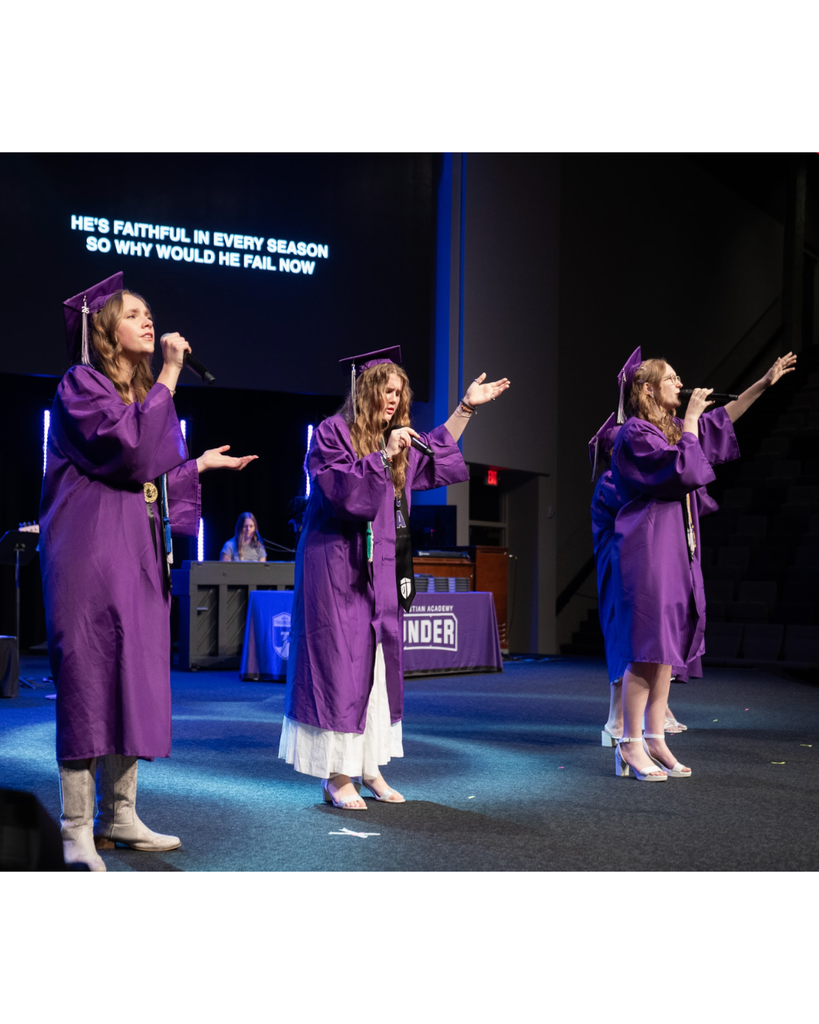 students signing on stage at graduation