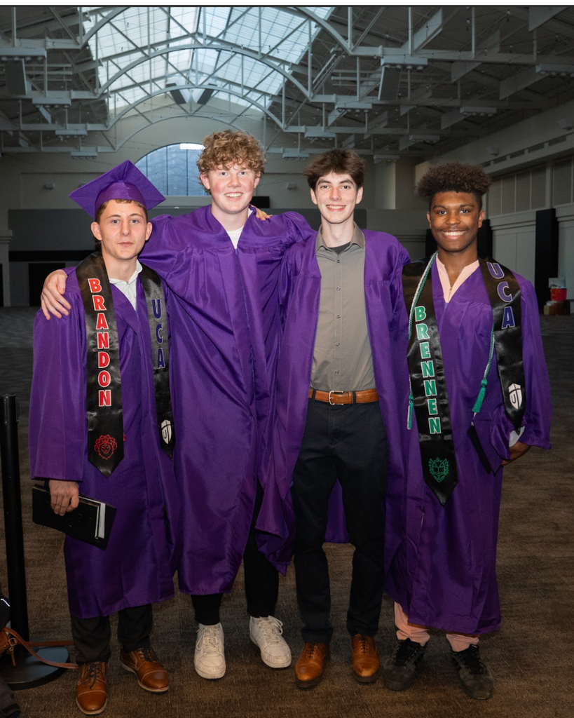 group of boys in graduation gowns