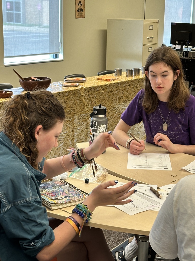 student rolling dice while playing a game