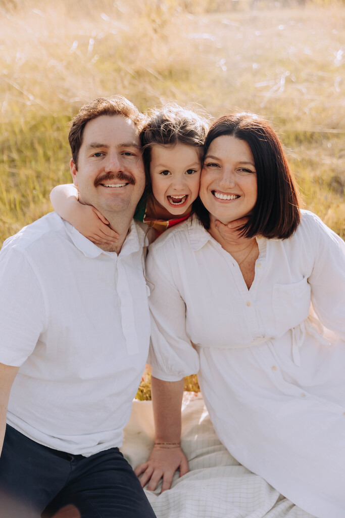 family picture of two parents and their daughter