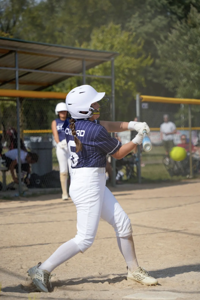 girl hitting a softball