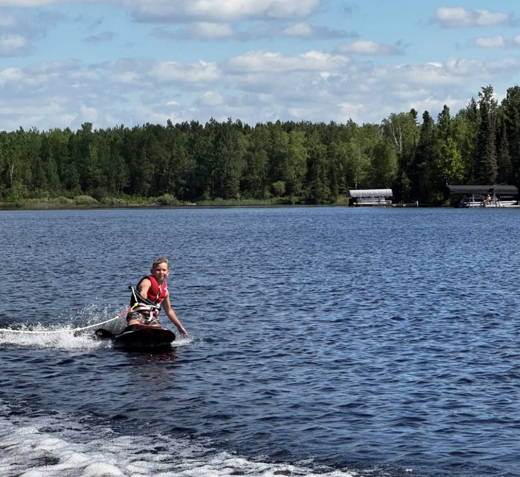 young boy wake boarding
