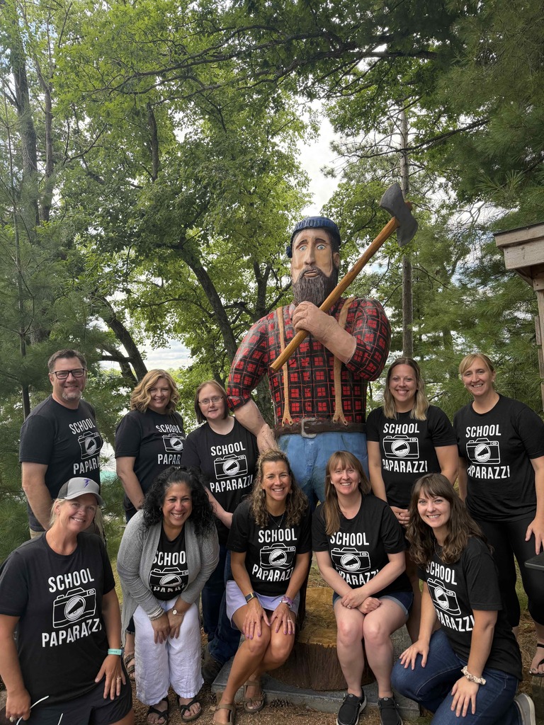 group picture of people gathered around a Paul Bunyan statue