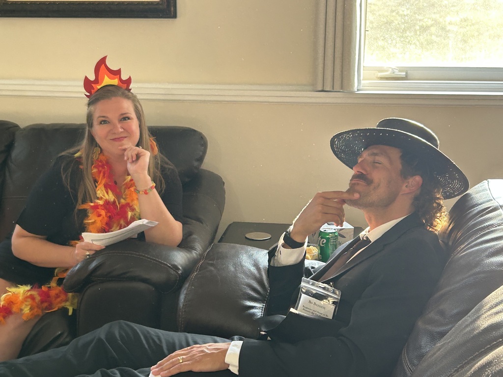 two people dressed up for a murder mystery dinner
