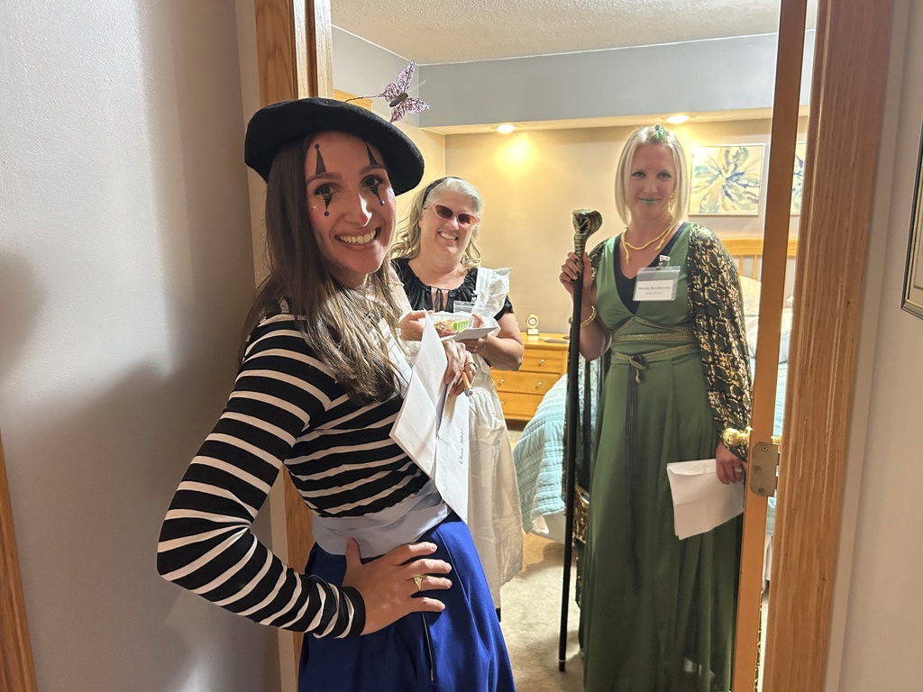 three women dressed in character for a murder mystery dinner