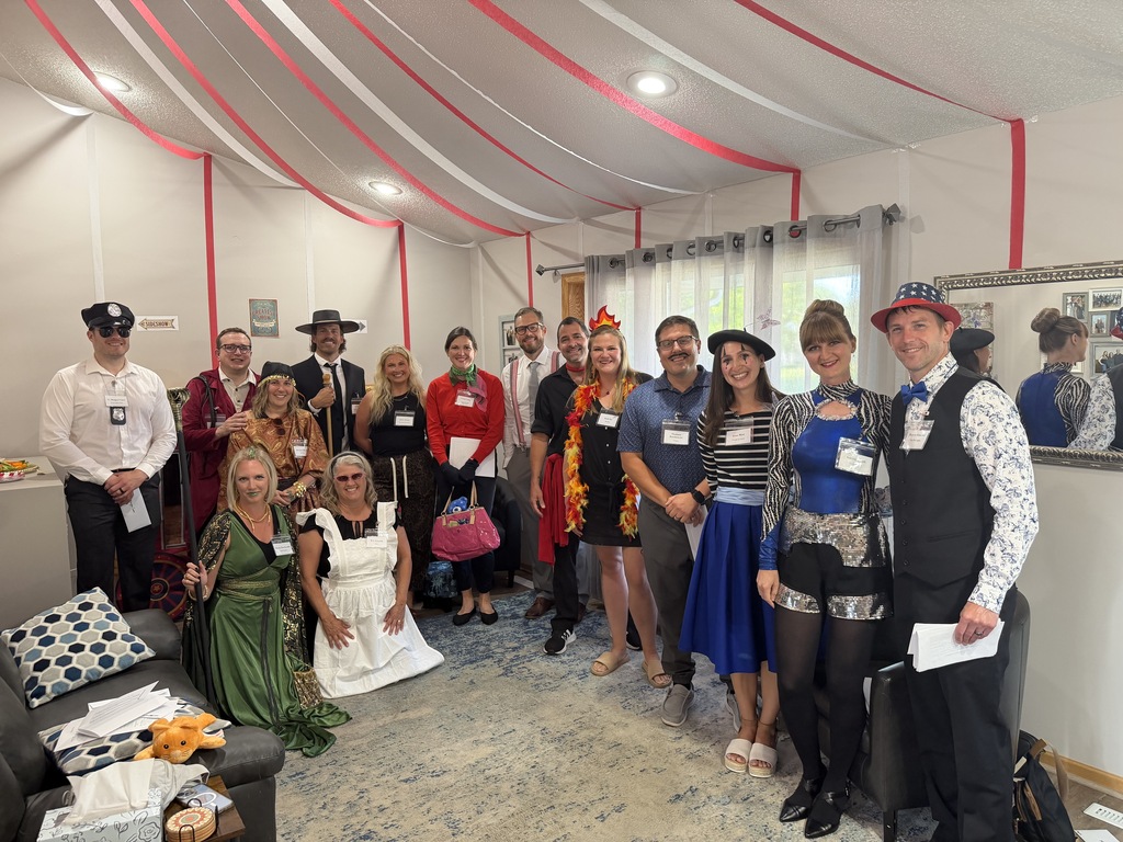 group photo of people dressed up for a murder mystery dinner