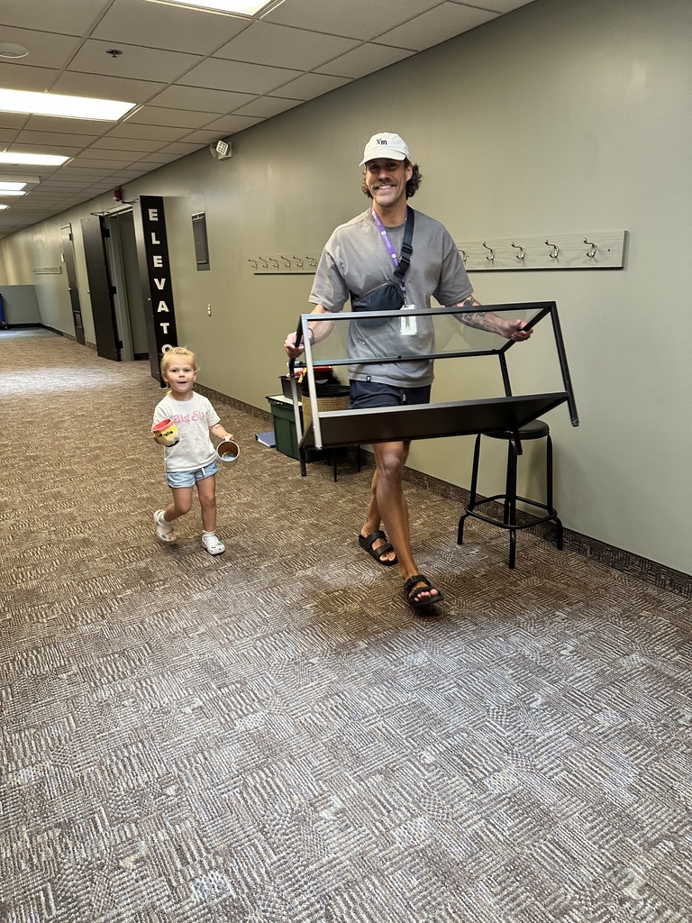 man and his daughter moving furniture