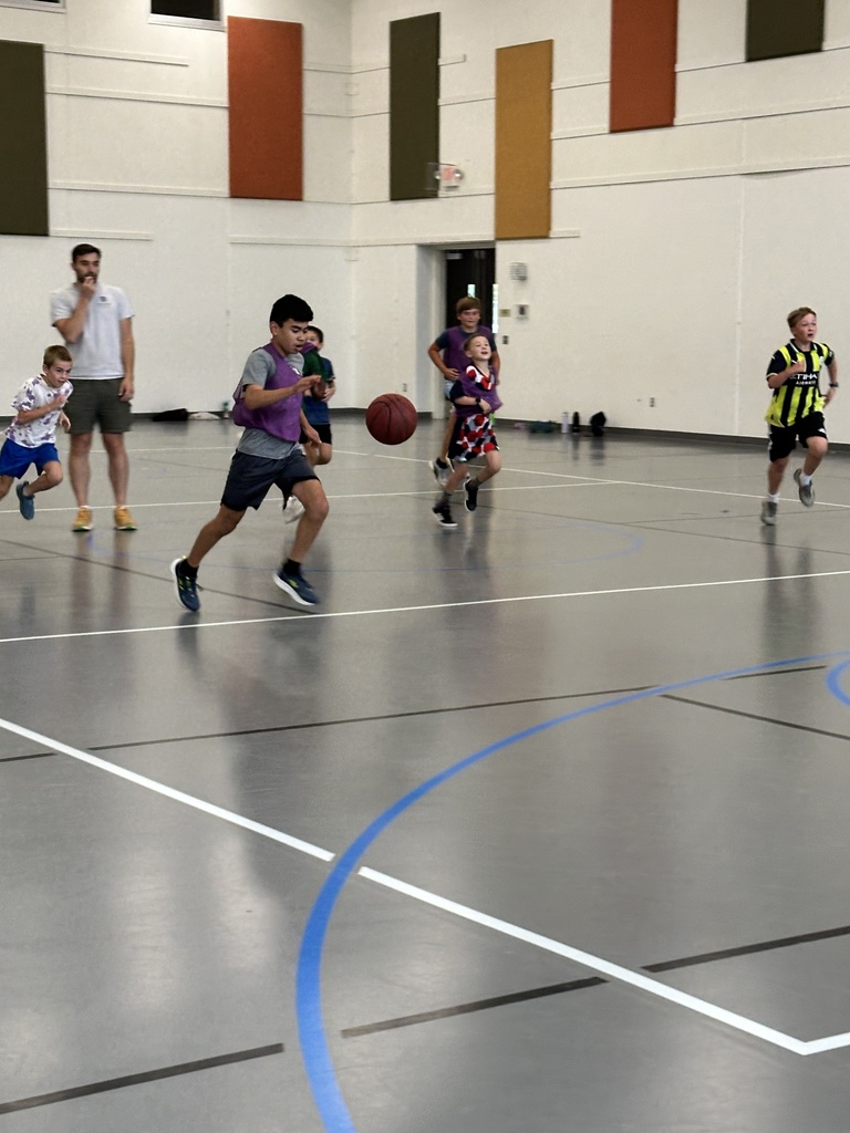 kids playing basketball in a gym