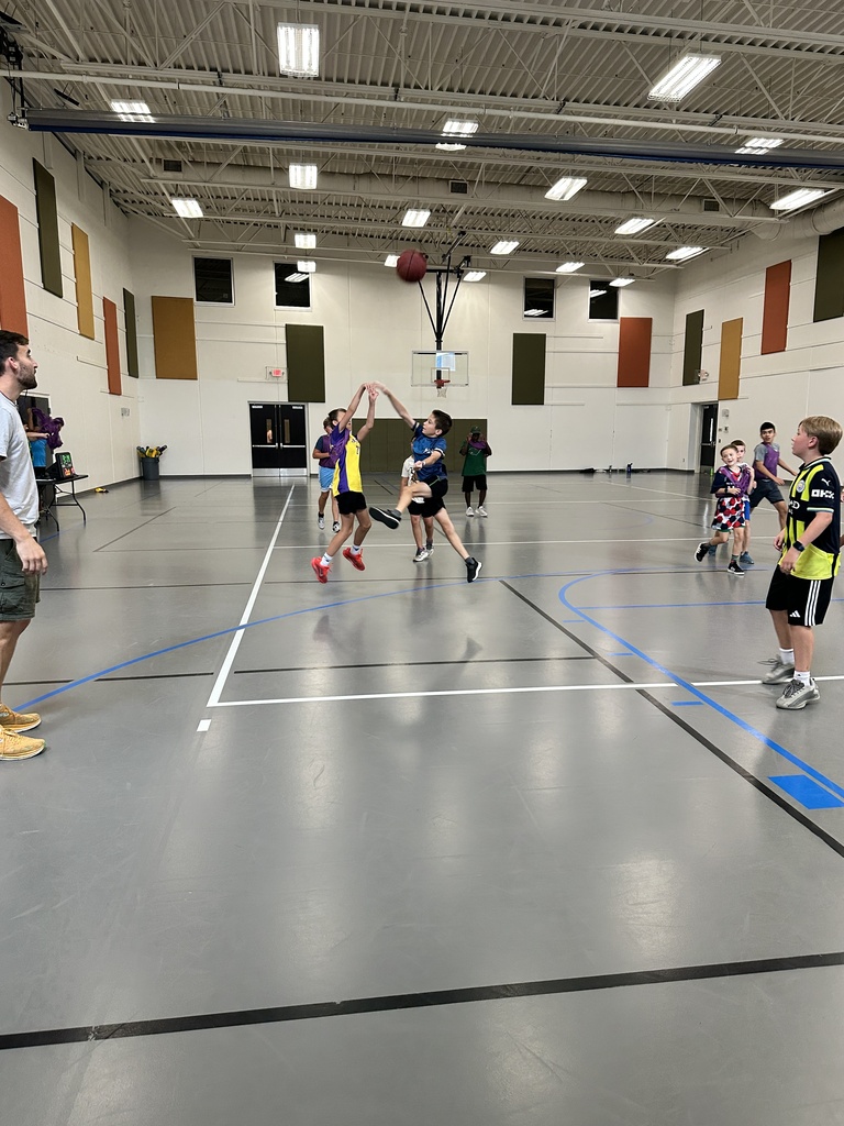 kids playing basketball in a gym