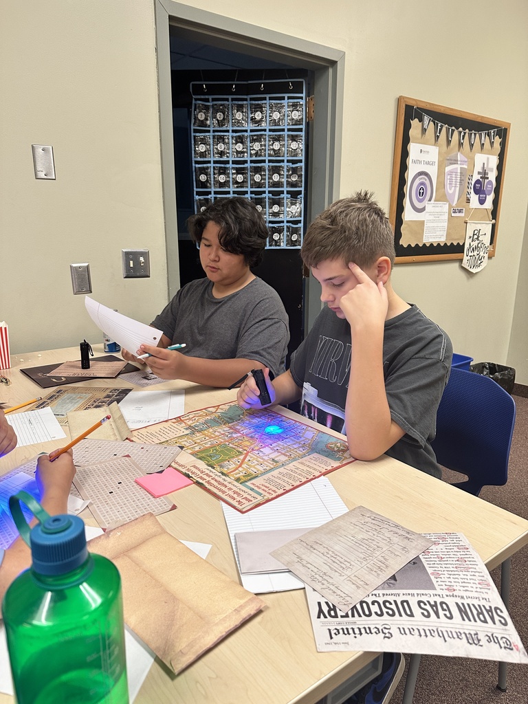 students using black lights to solve puzzles