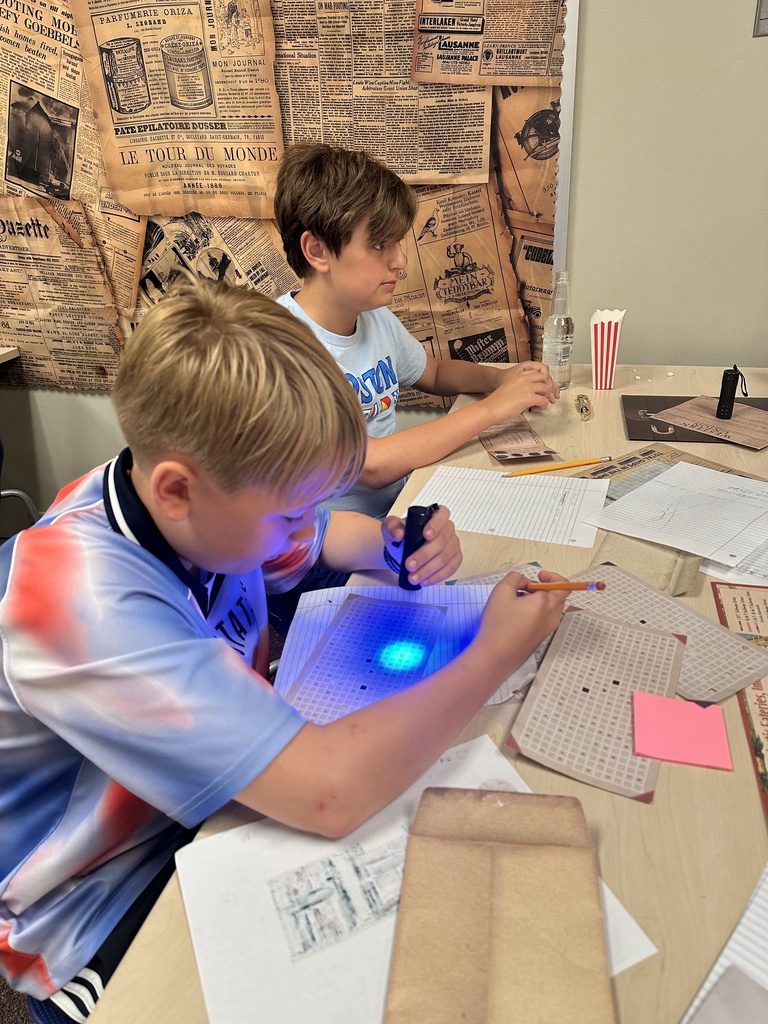 students using black lights to solve puzzles