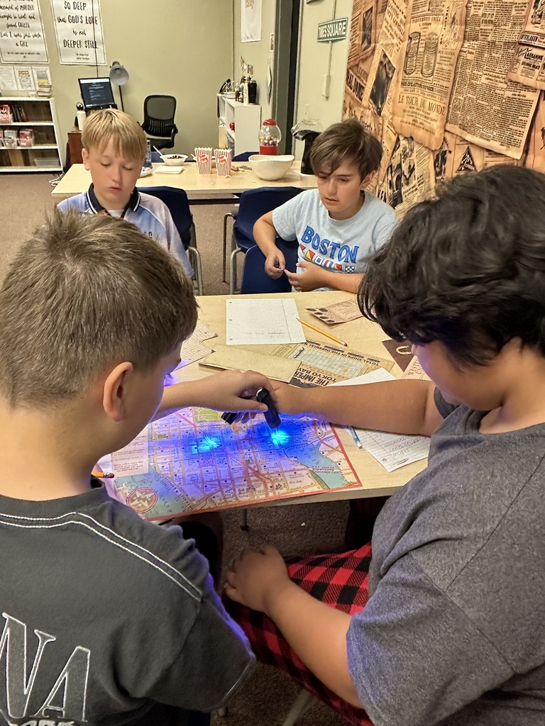 students using black lights to solve puzzles