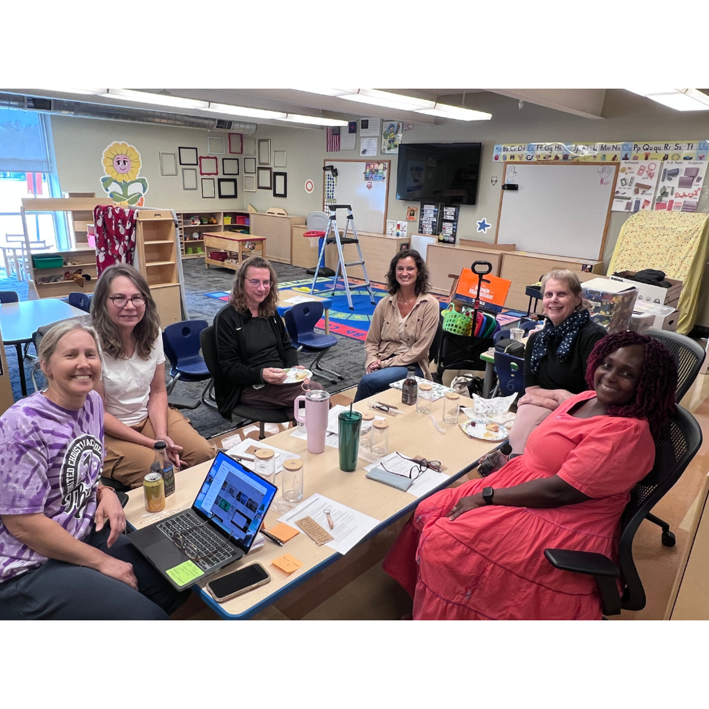 group of teachers sitting at a table