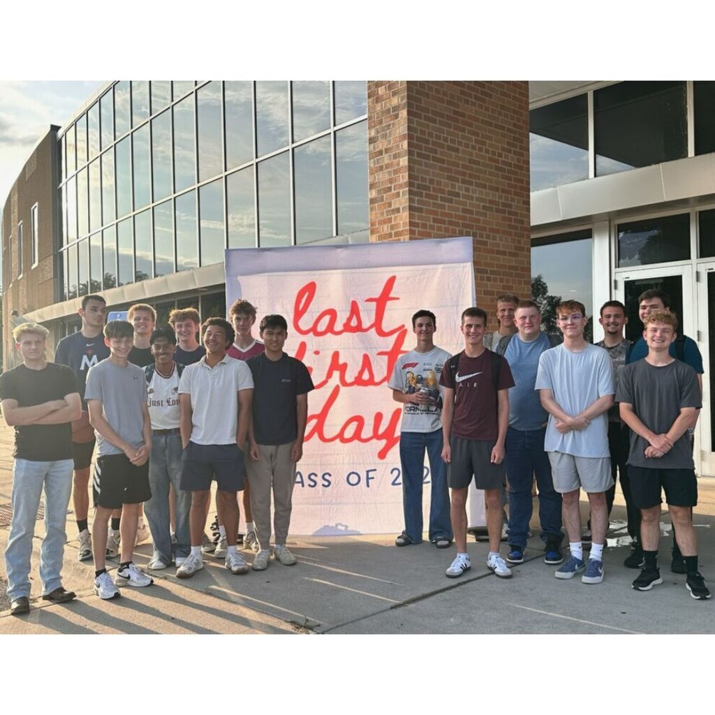 group of senior boys by a photo backdrop