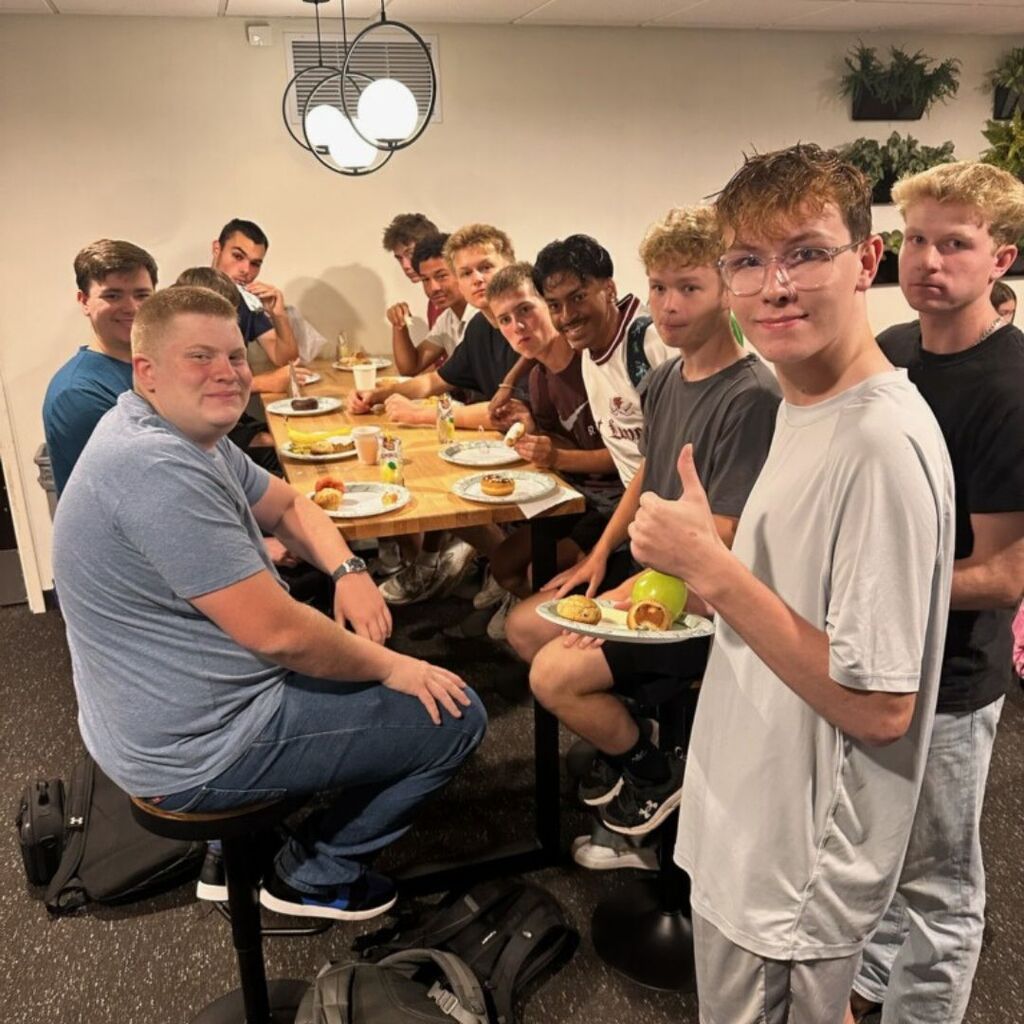 group of boys eating breakfast