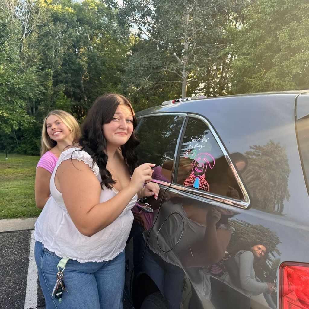 senior girls decorating their car